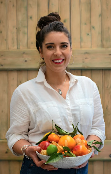 Erica Drum holding fruit